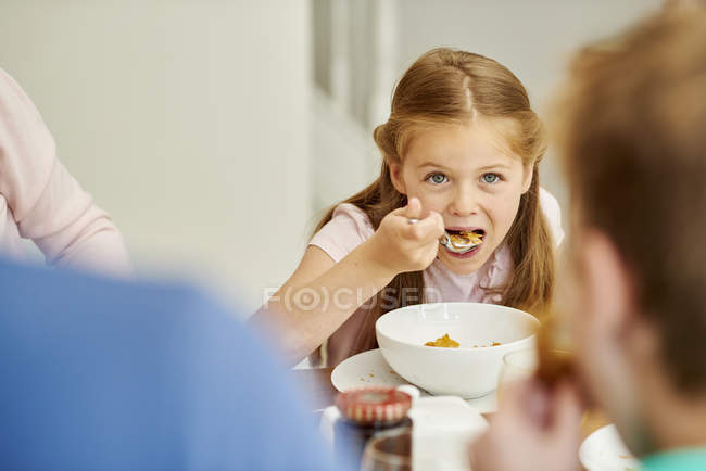 Girl eating cereal — Stock Photo