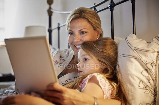Woman and child watching laptop screen. — Stock Photo