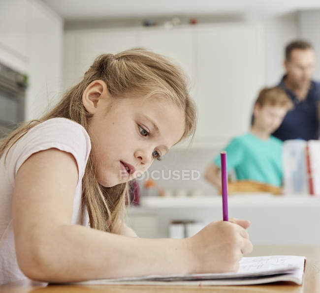 Girl sitting at a table — Stock Photo