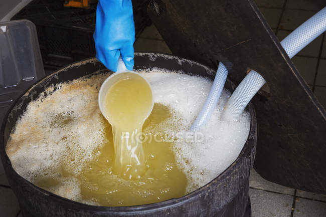 Person pouring apple juice — Stock Photo