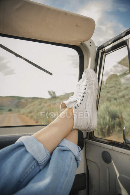 Feet on the dashboard of jeep. — Stock Photo