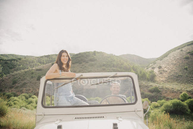 Woman standing up in jeep — Stock Photo
