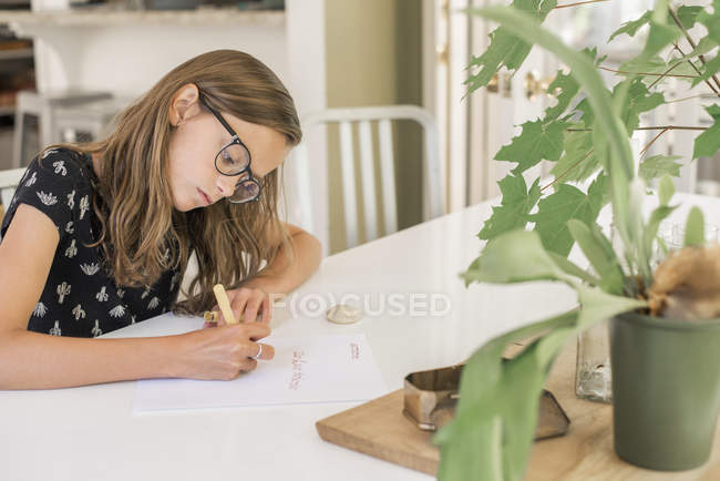 Young girl working at table — Stock Photo
