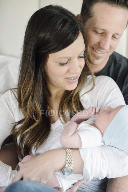 Parents holding a small baby — Stock Photo