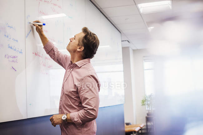 Man writing on whiteboard — Stock Photo