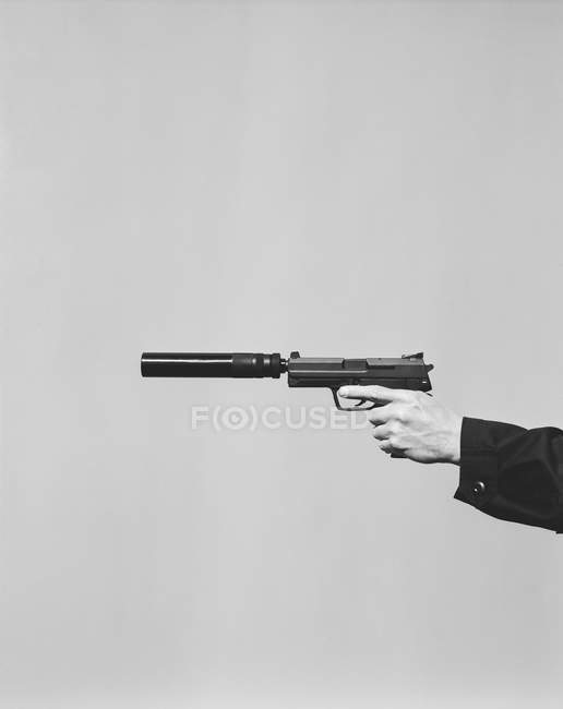 Male hand aiming with hand gun — Stock Photo