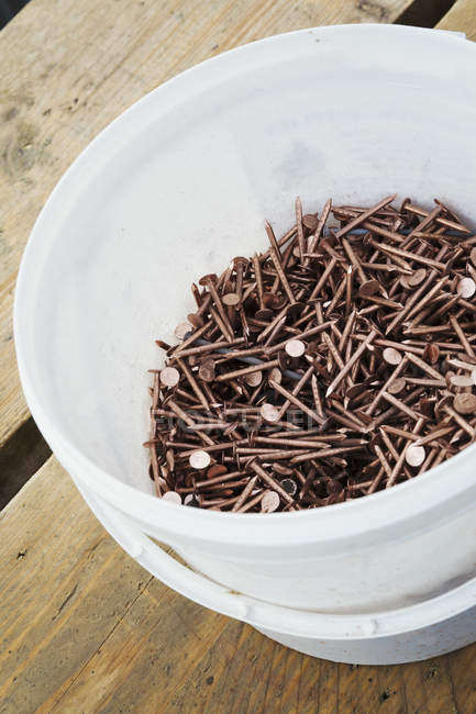 Bucket of copper nails — Stock Photo