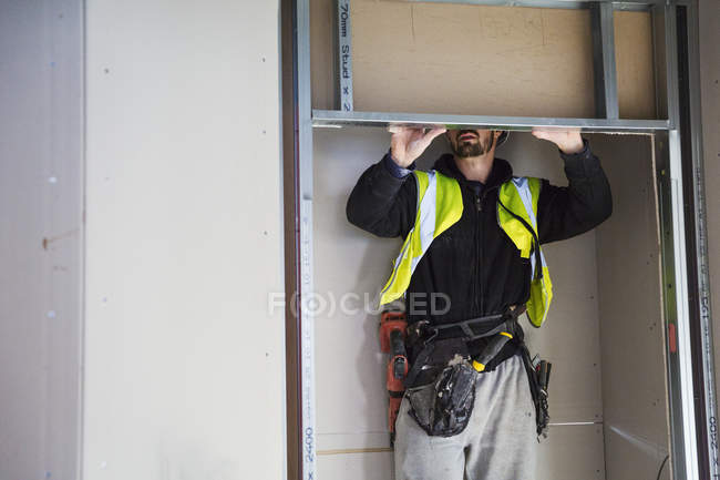 Carpenter fitting shelf — Stock Photo