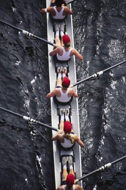 Female crew racers rowing — Stock Photo
