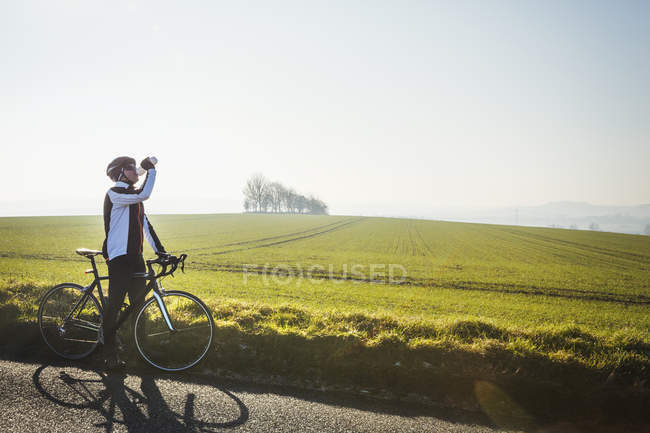 Велосипедист, имеющий перерыв и питьевую воду — стоковое фото
