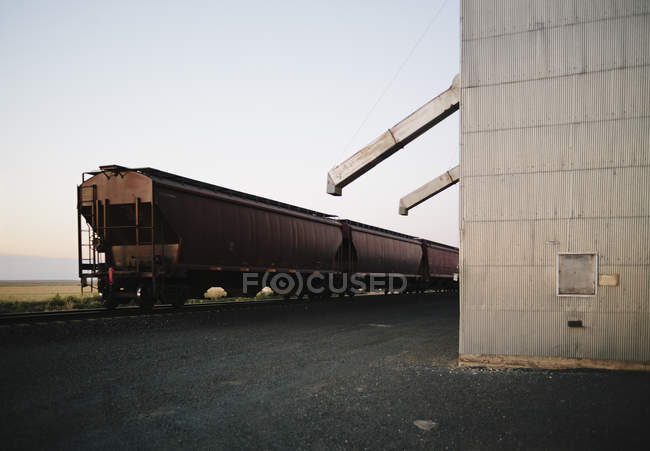 Freight train at station — Stock Photo