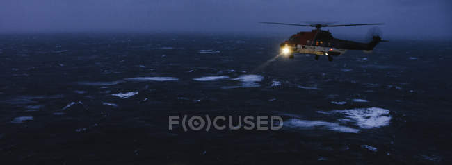 Helicopter flying over North Sea — Stock Photo