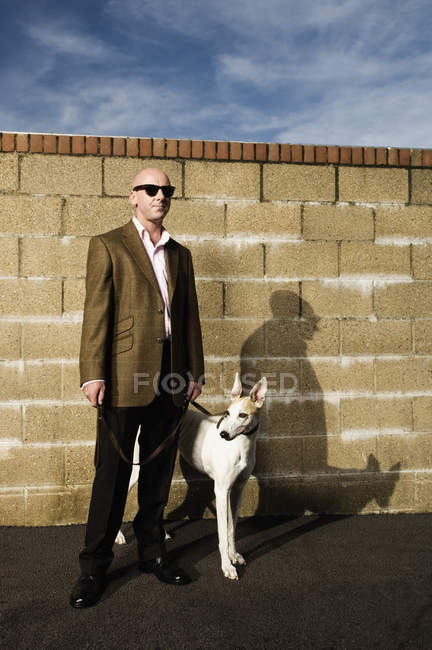 Man with greyhound on lead — Stock Photo