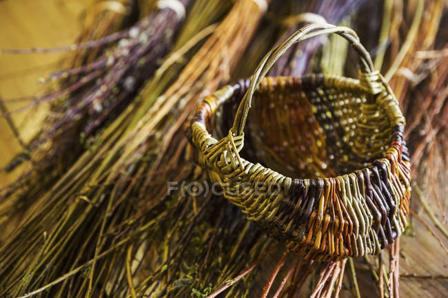 Basket and willow bundles — Stock Photo