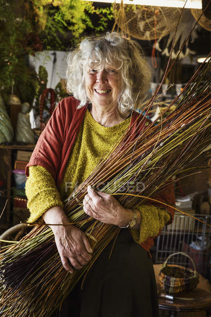 Woman holding willow bundle — Stock Photo