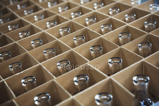 Empty bottles in cardboard boxes — Stock Photo