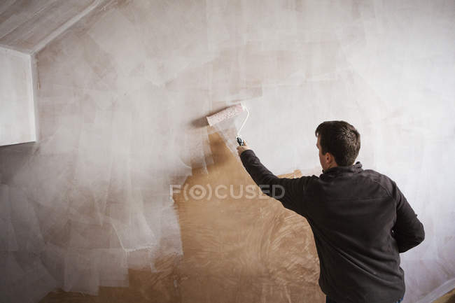Painter holding a paint roll — Stock Photo