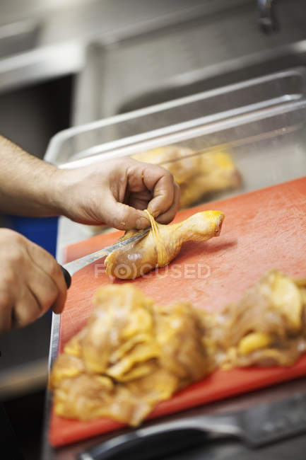 Chef preparing a chicken drumstick — Stock Photo