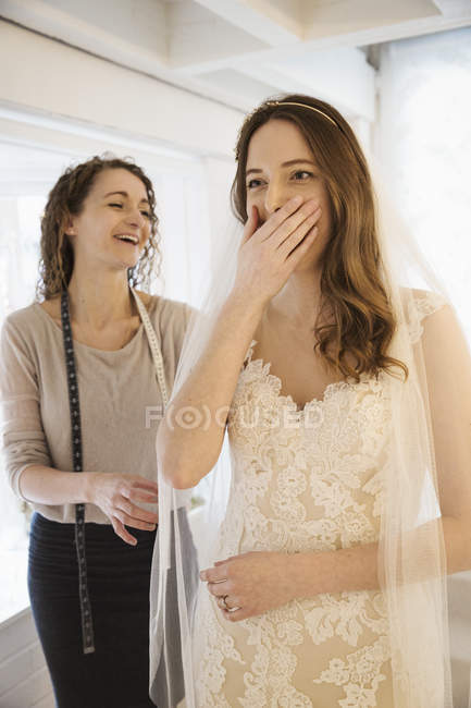 Молода жінка приміряє весільну сукню — стокове фото