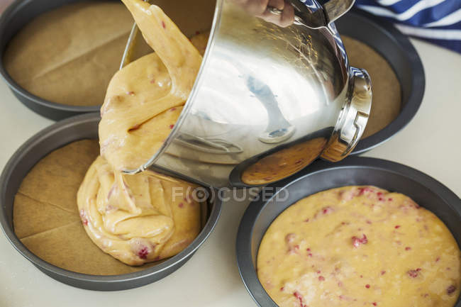 Batter being poured from bowl — Stock Photo