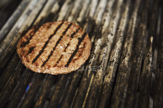 Close up, burger on griddle. — Stock Photo