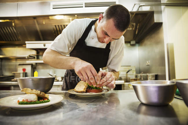 Chef standing in kitchen — Stock Photo