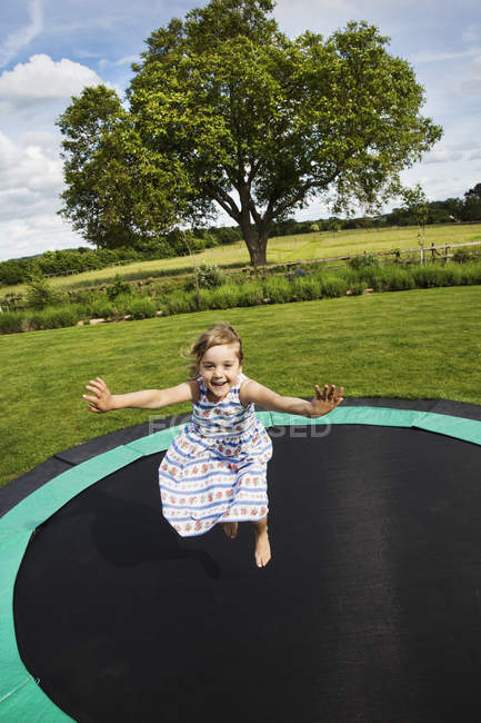 Girl jumping on  trampoline — Stock Photo