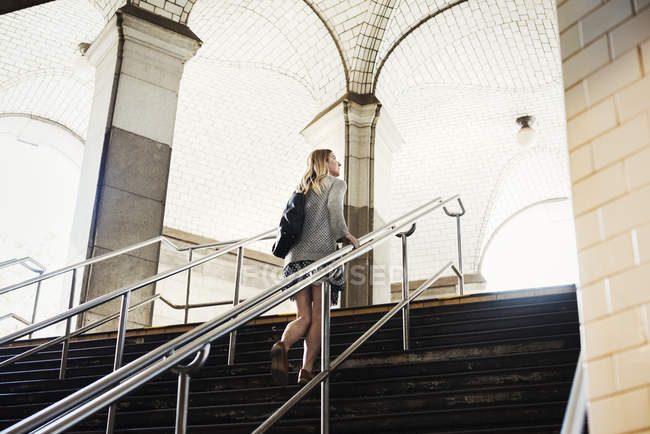 Woman walking up the steps — Stock Photo