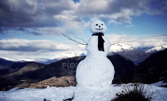 Snowman wearing a scarf — Stock Photo