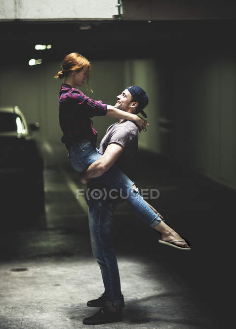 Couple dancing in underground parking — Stock Photo