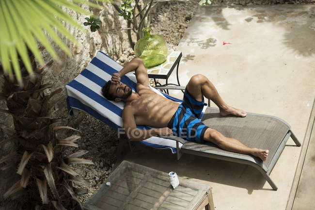 Man lying on sun lounger. — Stock Photo