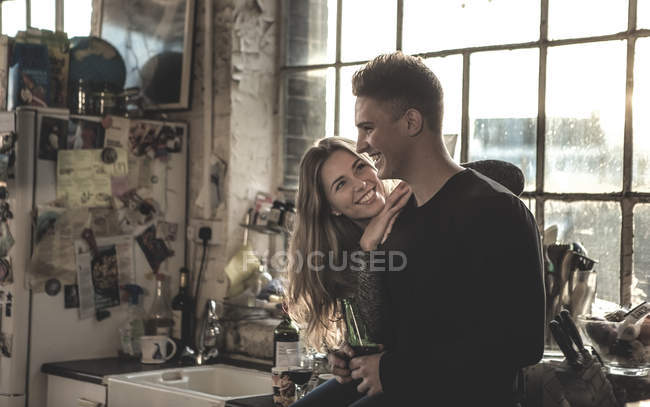Woman and man standing indoors by window. — Stock Photo