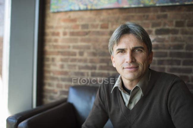 Mature man sitting in cafe interior — Stock Photo