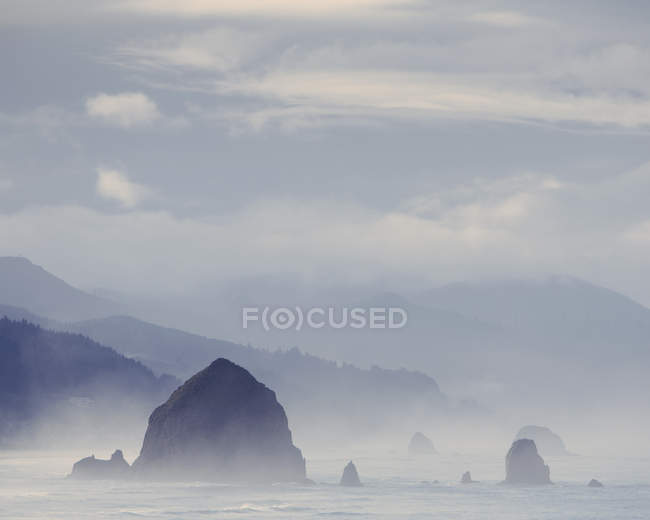 Foggy view of Haystack Rock — Stock Photo