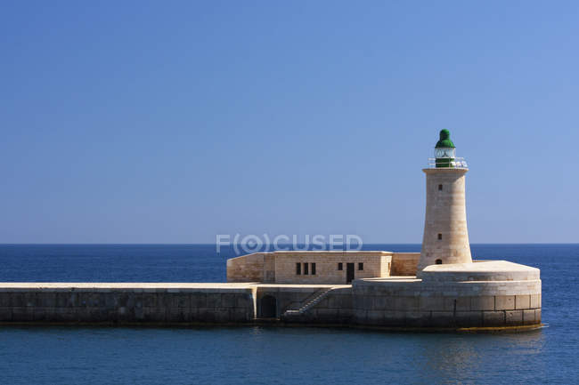 View of lighthouse in the harbour — Stock Photo
