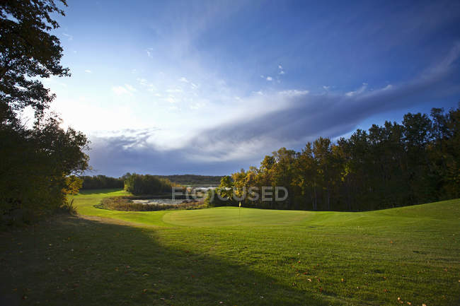 Green and sunny fairway at country golf course. — Stock Photo