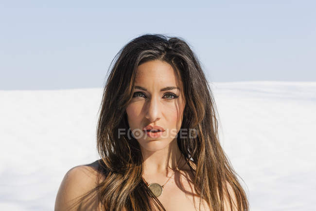 Portrait of young woman outdoors in snow. — Stock Photo