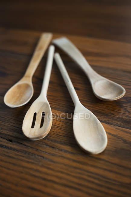 Bleached wooden spoons on wooden tabletop. — Stock Photo