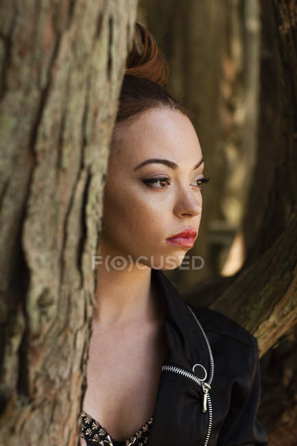 Young woman with makeup and severe expression in leather jacket. — Stock Photo
