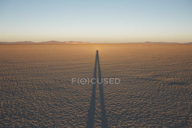 Shadow of person on Black Rock Desert Playa at dusk, Nevada, USA — Stock Photo