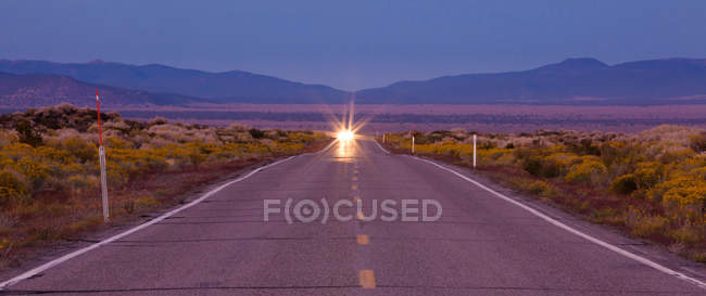 Car lights on road through prairie in Bodie, California, USA — Stock Photo