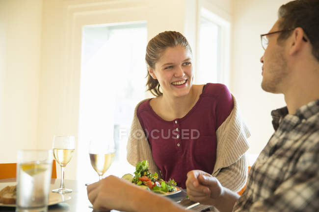 Jeune homme et femme mangeant et buvant du vin au café . — Photo de stock