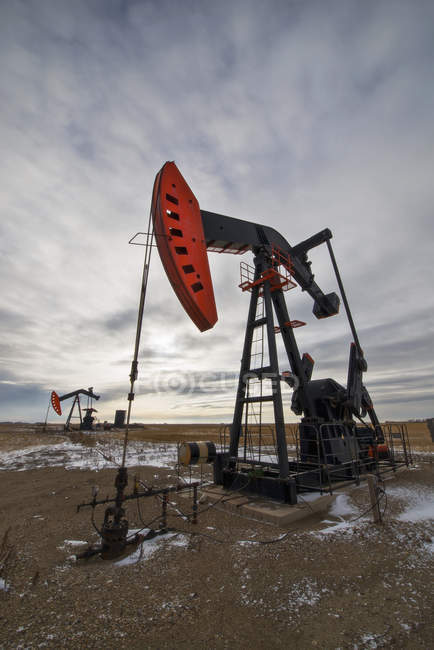 Oil pumpjack at drilling site on oil field in Saskatchewan, Canada. — Stock Photo