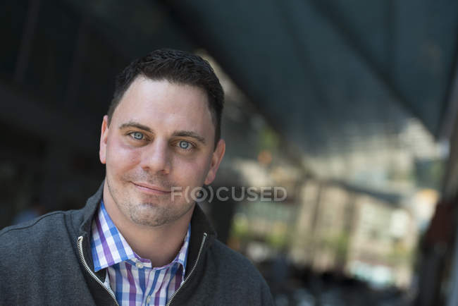 Portrait of mid adult man in a open-necked shirt and jacket. — Stock Photo