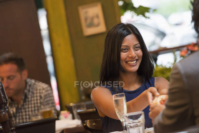 Coppia sorridente e tenendosi per mano a tavola in interno caffè . — Foto stock