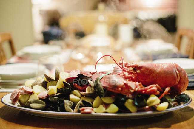 Prato de frutos do mar com lagosta e amêijoas na mesa servida . — Fotografia de Stock