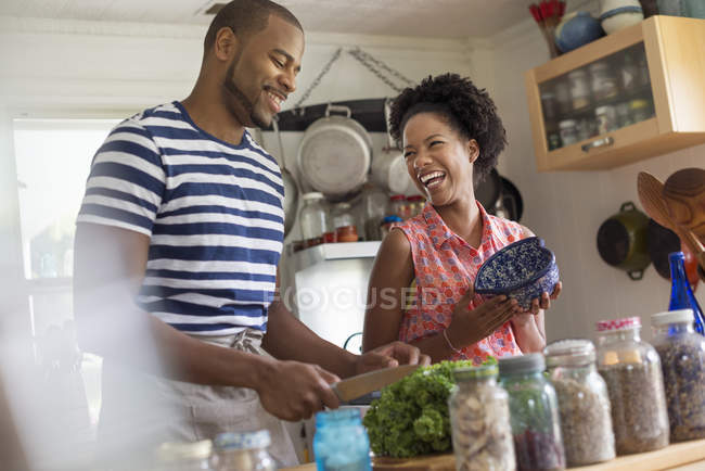 Couple preparing dinner in country kitchen interior. — Stock Photo