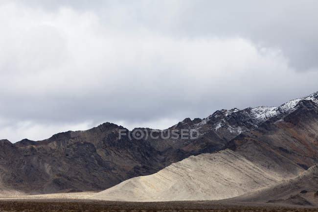 Сніг накривав гір і зловісний небо в Долина смерті Національний парк. — стокове фото