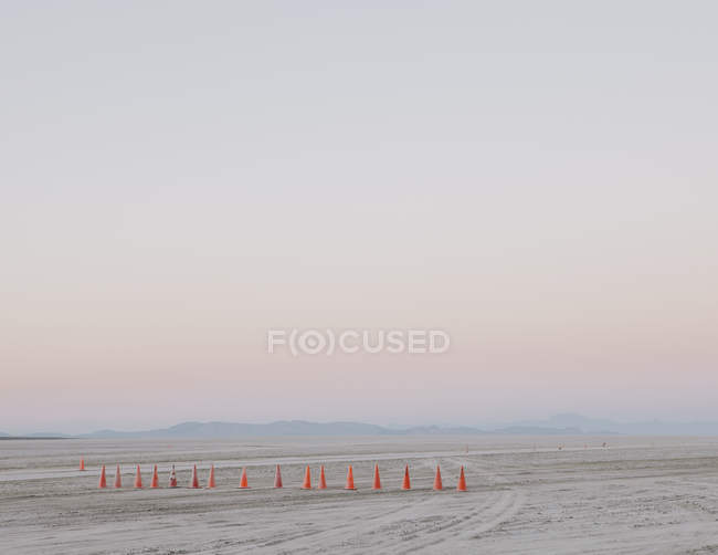 Row of traffic cones on flat desert surface of Black Rock, Nevada. — Stock Photo
