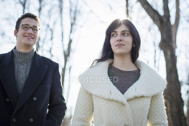 Young couple walking in woods in winter. — Stock Photo